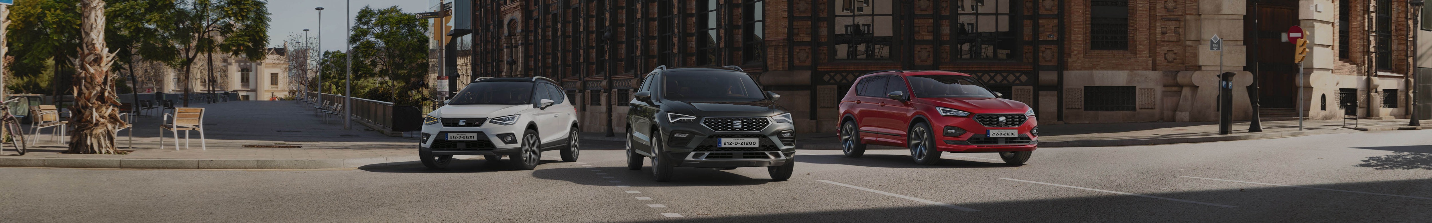 SEAT Arona desire red side view and woman hold a cup