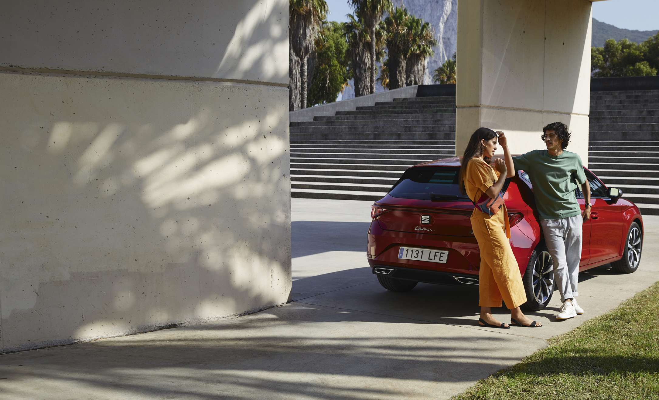 SEAT Ireland personal car leasing couple standing at their new desire red colour SEAT Ibiza city car