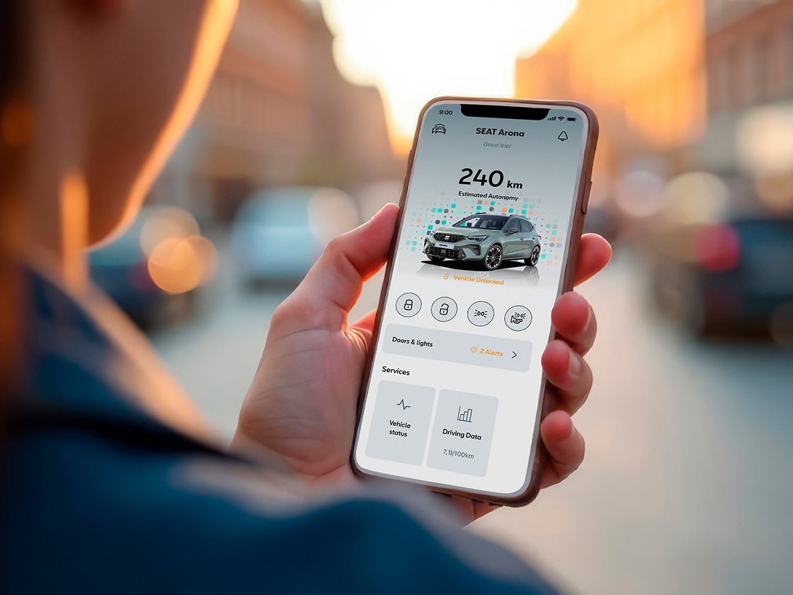 Person holding their smartphone using my SEAT app Person holding their smartphone using my SEAT app