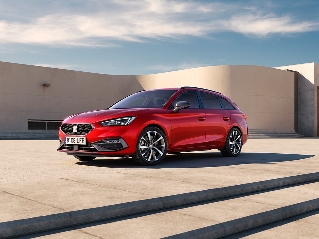 The seat leon sportstourer fr with sleek alloy wheels and an engaging drive profile. The standout vehicle in the range from seat is set against an outdoors background.
