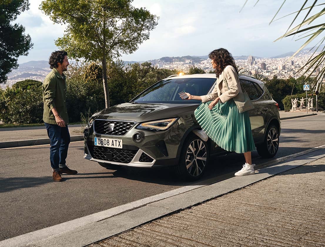 man woman standing beside seat arona