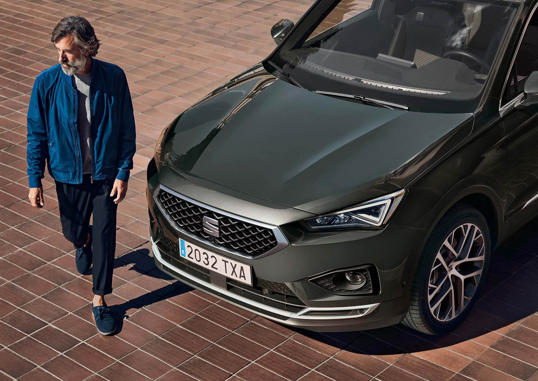 Man in front of the new SEAT Tarraco XPERIENCE with alloy wheels