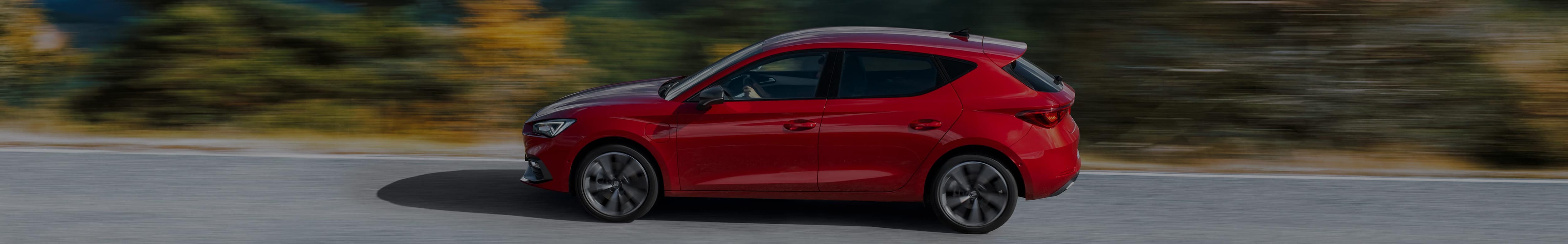 New SEAT Leon in red colour on the road