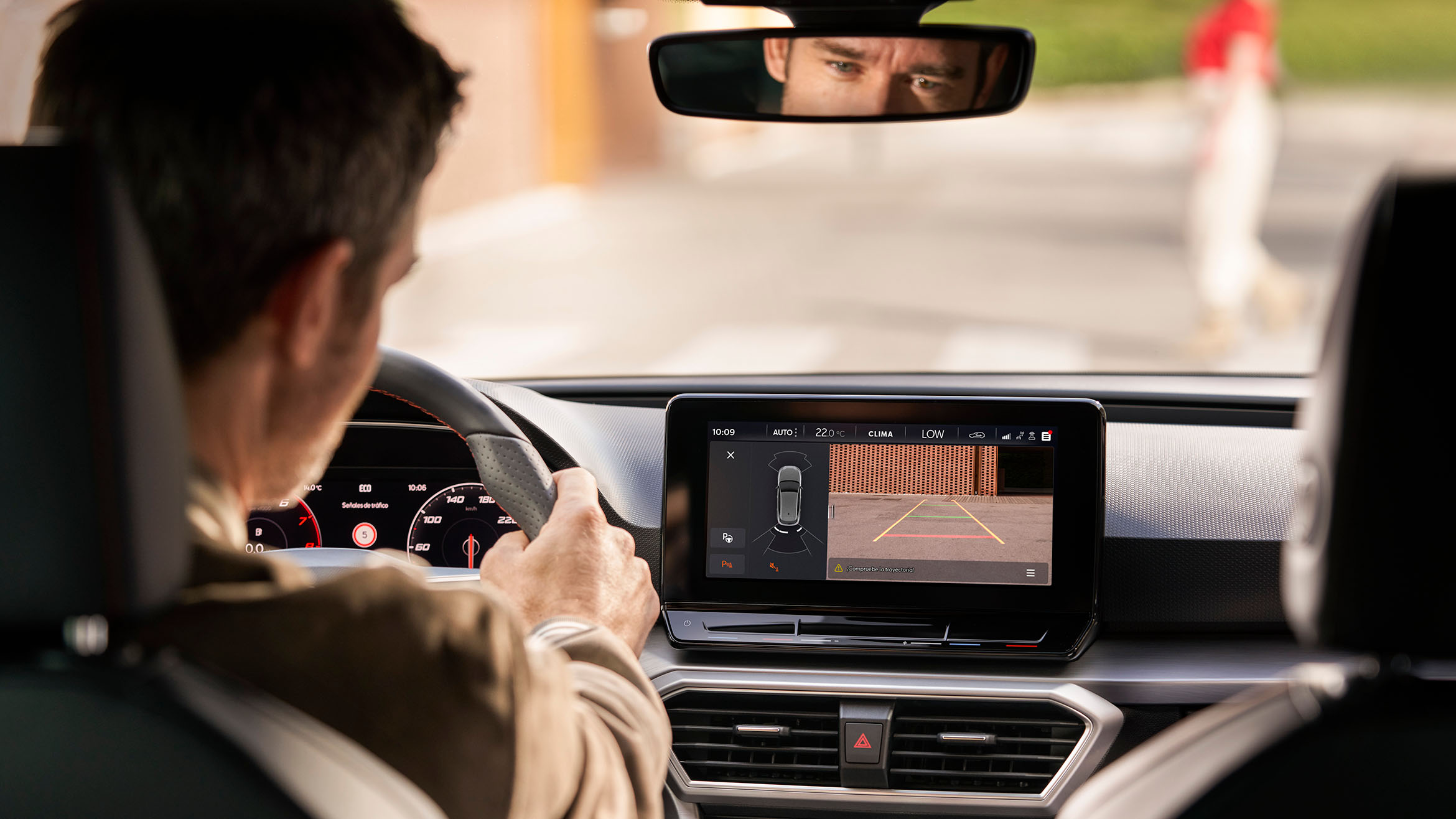 man driving a SEAT Leon using the navigation system