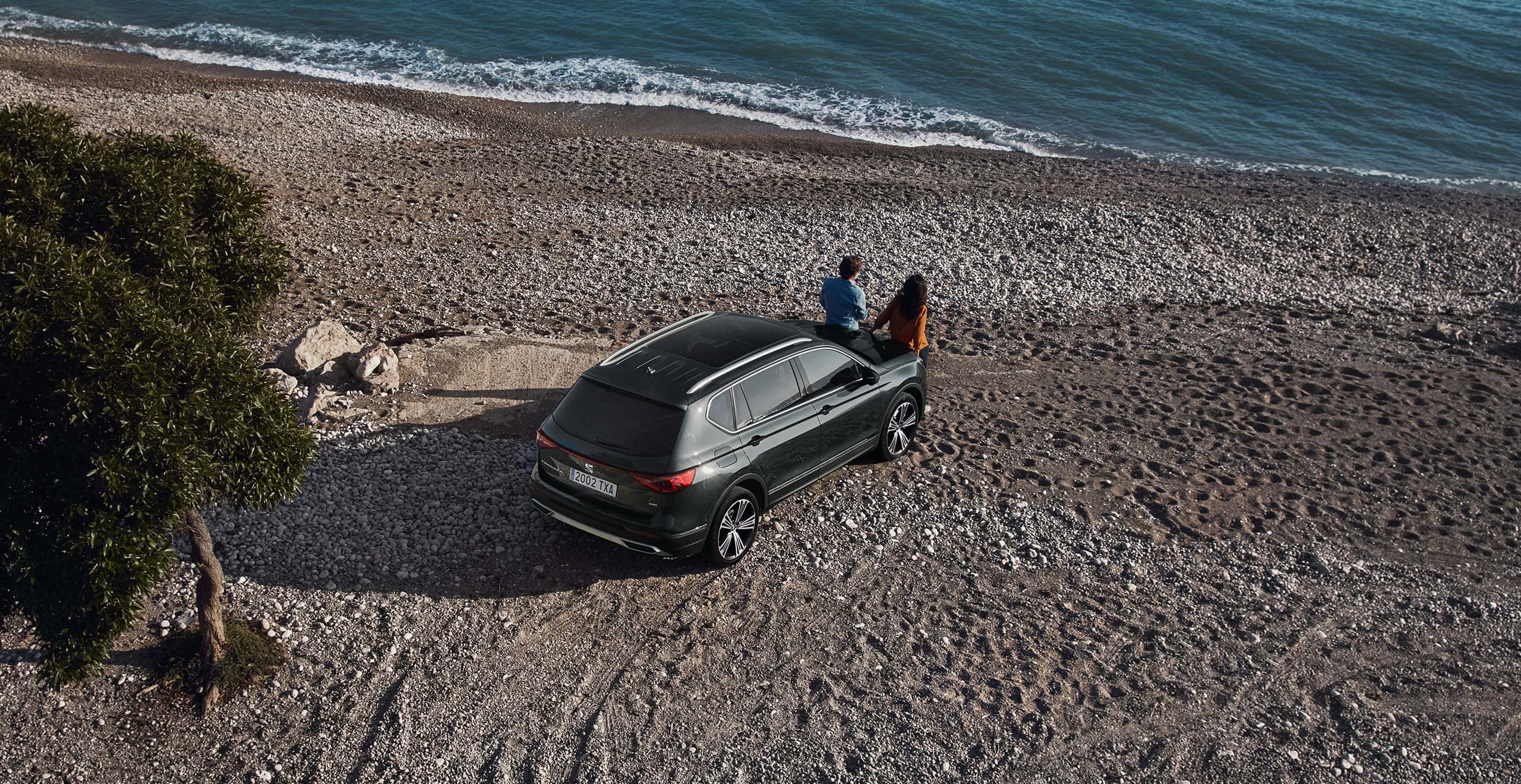 SEAT Tarraco 2021 SUV in dark camouflage colour parked at beach